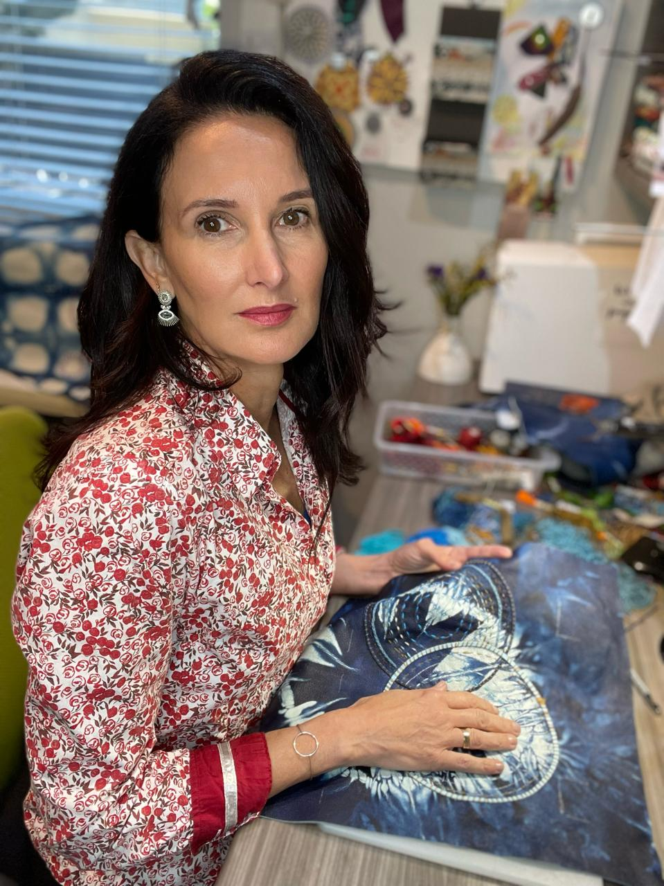 Flavia, Pessoa founder and designer, working with patterned fabric in her studio